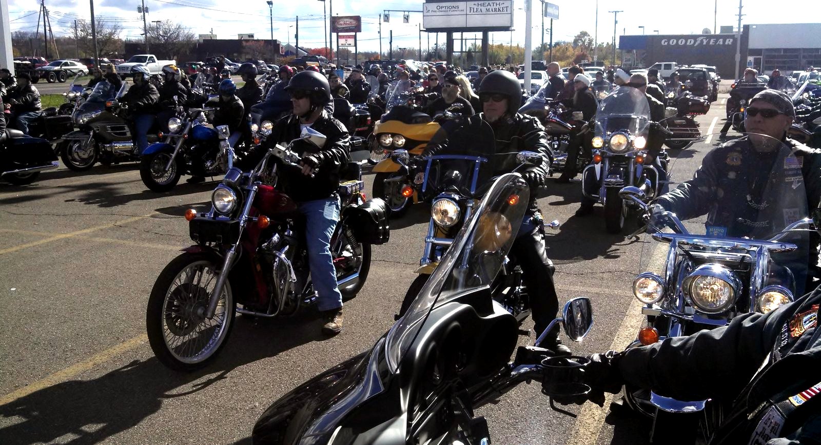 A long lineup of riders on their motorcycles, queued up and ready to roll out at the Toy Run