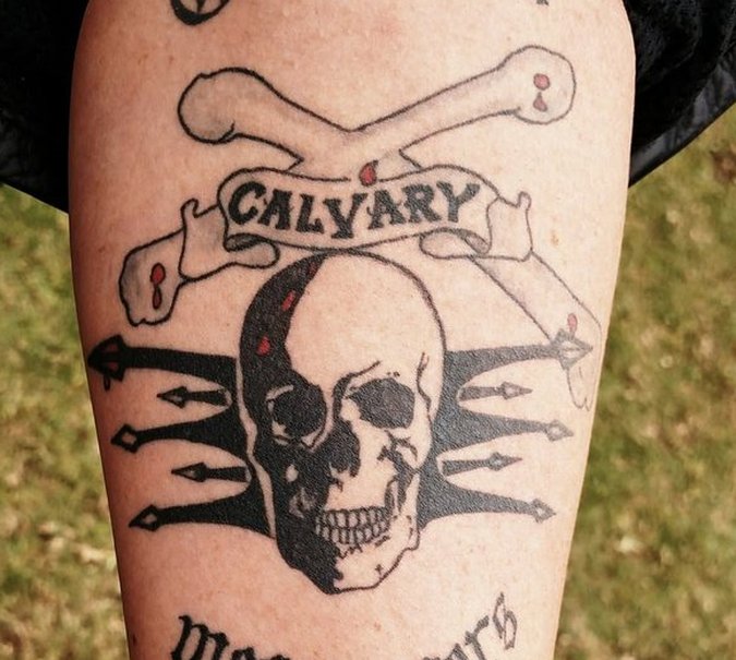 The Calvary skull-and-crossbones emblem tattooed on a rider's forearm, from a Rev It Up outreach in South Africa