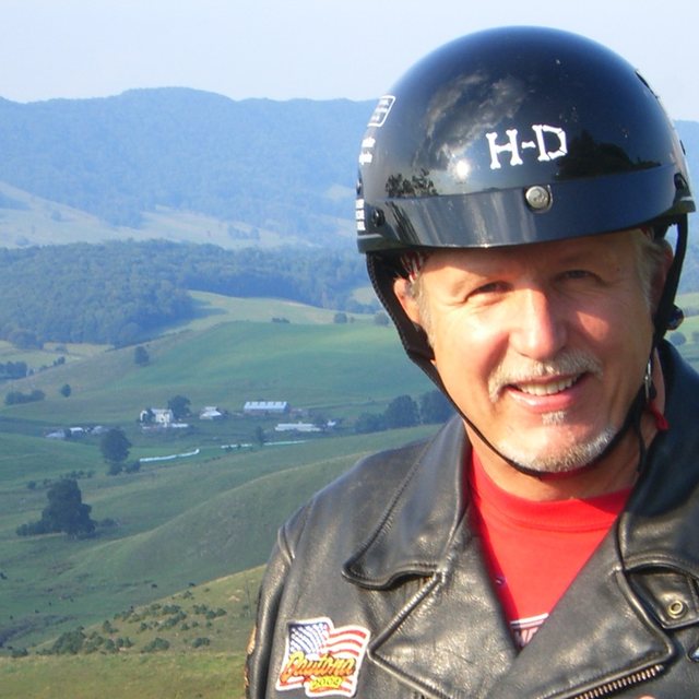 Pastor Tom Hughes in his leather jacket and helmet above the Blue Ridge