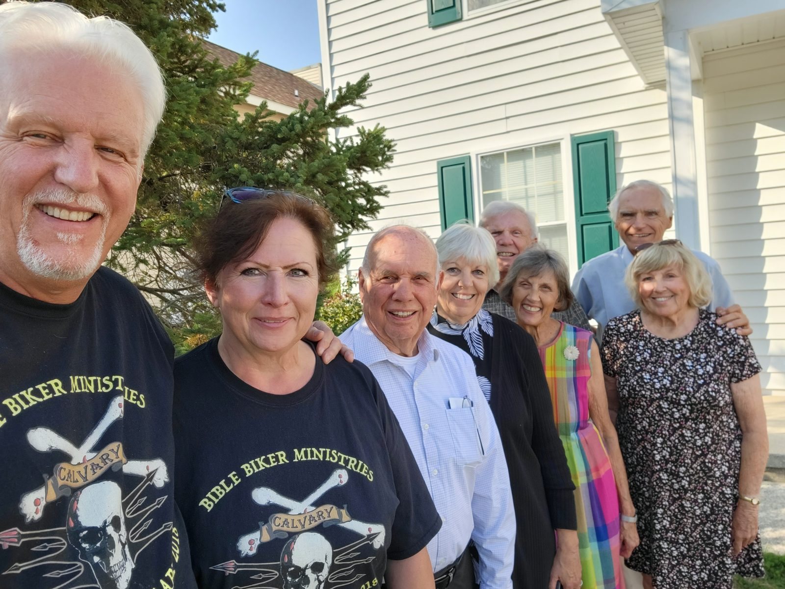 Tom and Cathy Hughes with friends in Bible Biker Ministries shirts outside a church