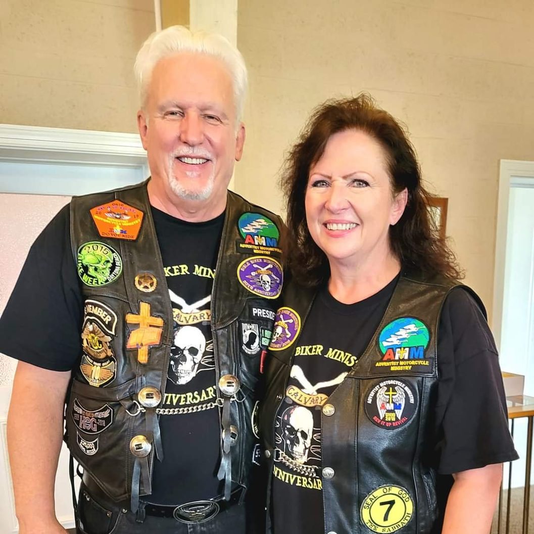 Tom and Cathy Hughes side by side in their patched leather vests